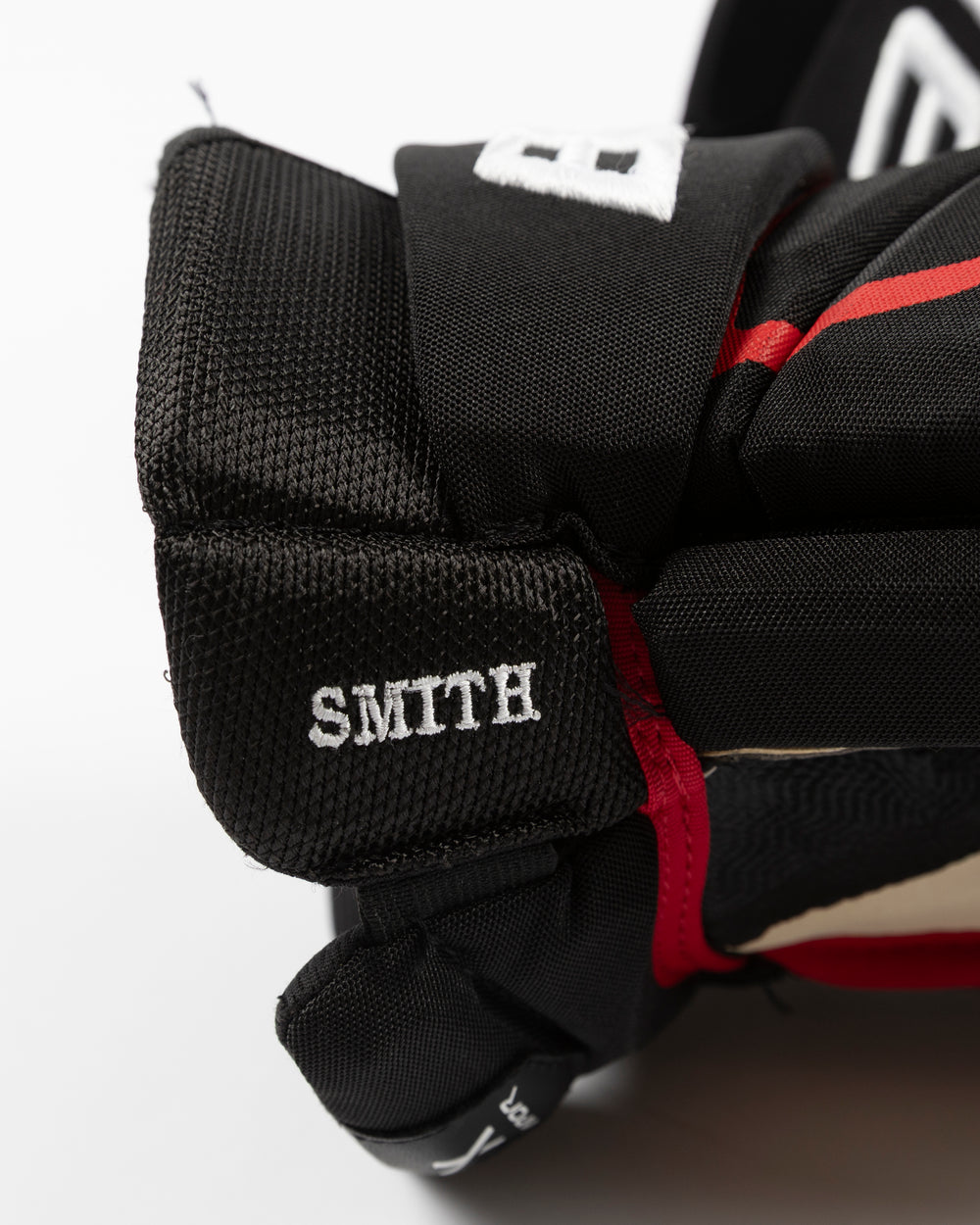 black Bauer hockey gloves used by Chicago Blackhawks player Craig Smith - name detail lay flat