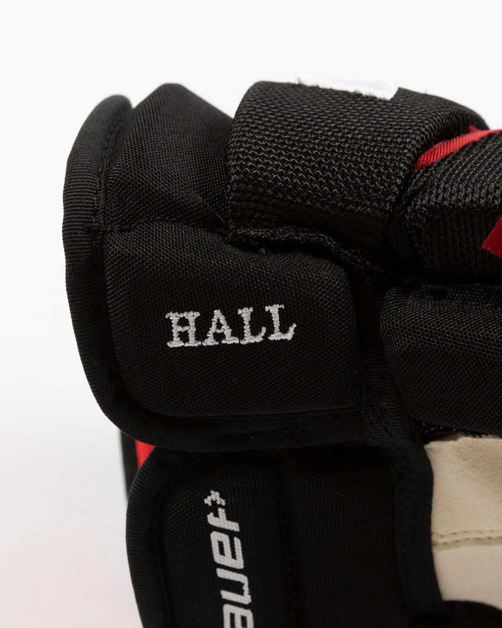 black Bauer hockey gloves used by Chicago Blackhawks player Taylor Hall - name detail lay flat