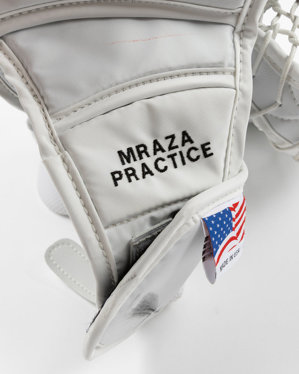 white and red Vaughn hockey goalie glove used by Chicago Blackhawks goalie Petr Mrazek - name detail lay flat