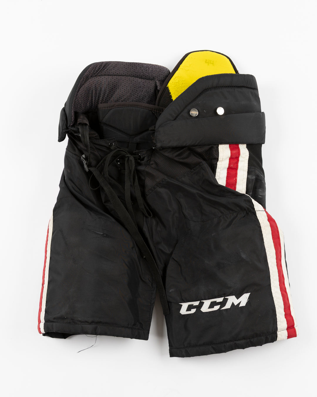 black CCM hockey pants used by Chicago Blackhawks player Wyatt Kaiser - front lay flat