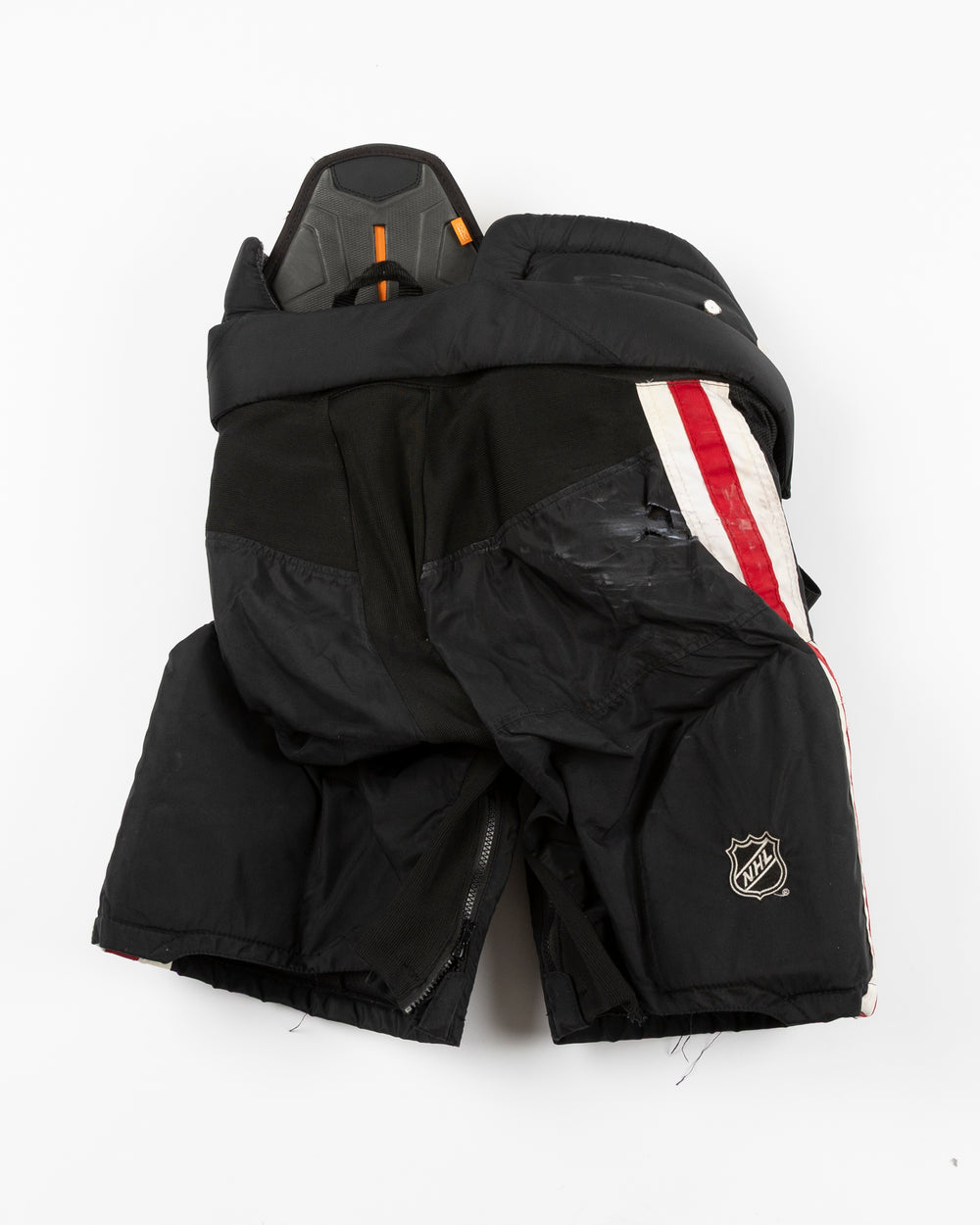 black CCM hockey pants used by Chicago Blackhawks player Wyatt Kaiser - back lay flat