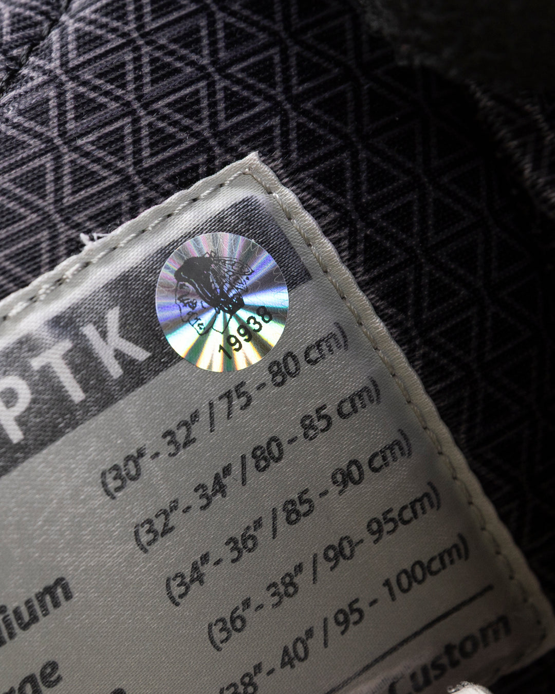 black CCM hockey pants used by Chicago Blackhawks player Wyatt Kaiser - hologram sticker detail lay flat