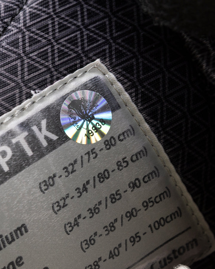 black CCM hockey pants used by Chicago Blackhawks player Wyatt Kaiser - hologram sticker detail lay flat