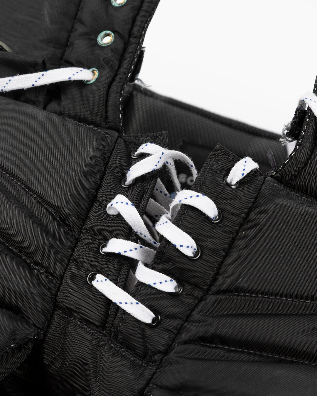 black Vaugh hockey pants used by Chicago Blackhawks goalie Arvid Soderblom - lace detail lay flat