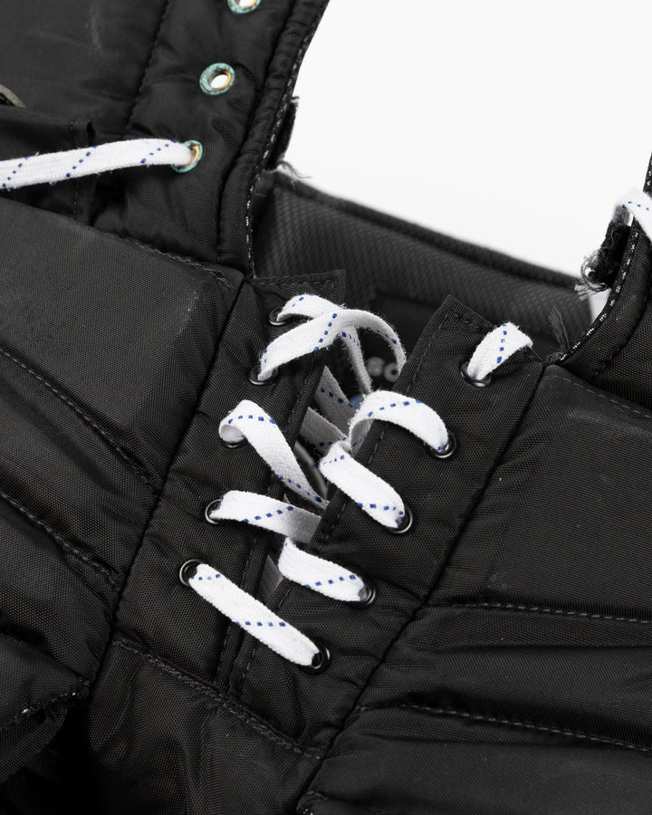 black Vaugh hockey pants used by Chicago Blackhawks goalie Arvid Soderblom - lace detail lay flat