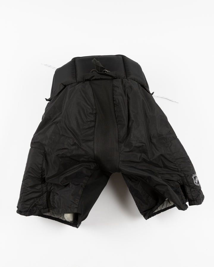 black Vaugh hockey pants used by Chicago Blackhawks goalie Arvid Soderblom - back lay flat
