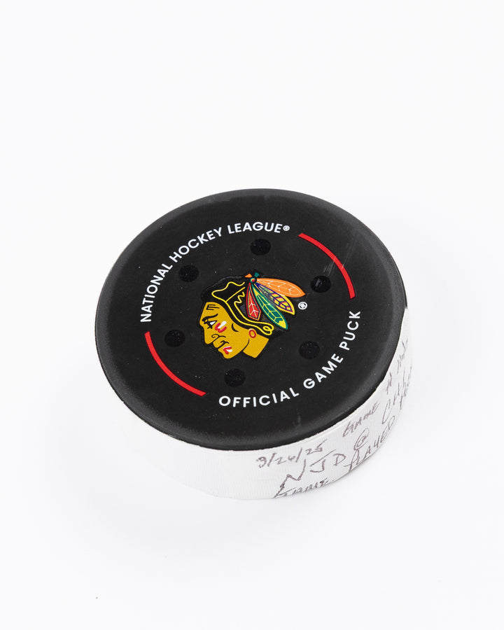 official Chicago Blackhawks hockey puck used in game against the New Jersey Devils on 3/26/25 - front angle lay flat