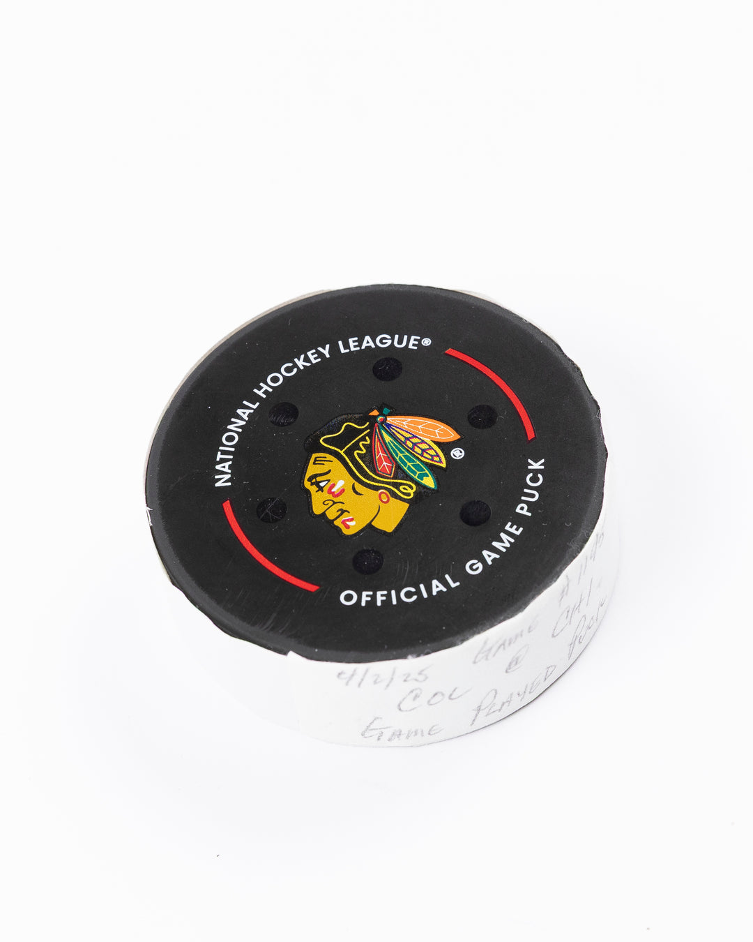 official Chicago Blackhawks hockey puck used in game against the Colorado Avalanche on 4/2/25 - front angle lay flat