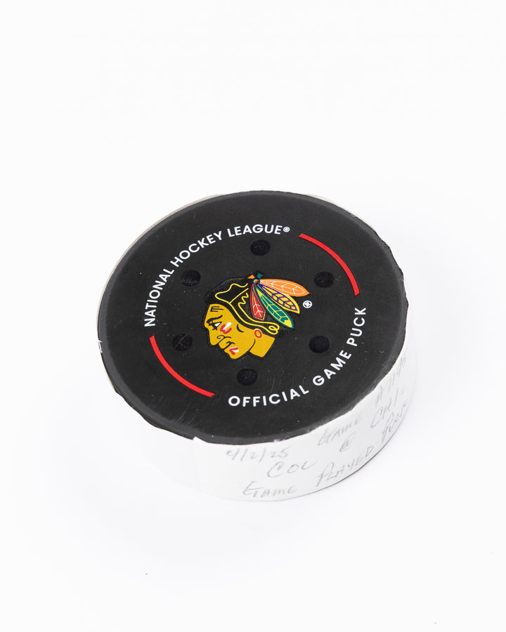 official Chicago Blackhawks hockey puck used in game against the Colorado Avalanche on 4/2/25 - front angle lay flat