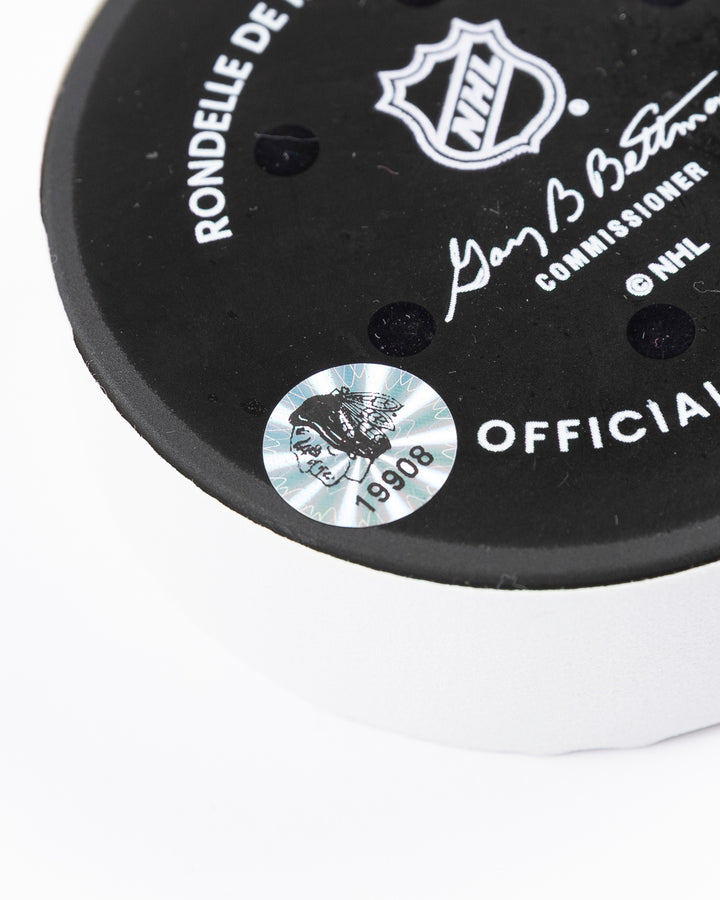 official Chicago Blackhawks hockey puck used in game against the Colorado Avalanche on 4/2/25 - hologram sticker detail lay flat