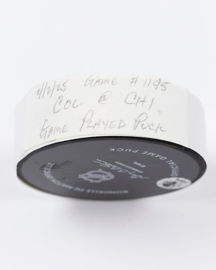official Chicago Blackhawks hockey puck used in game against the Colorado Avalanche on 4/2/25 - tape detail lay flat
