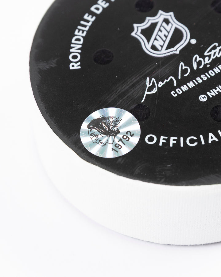 official Chicago Blackhawks hockey puck used in game against Los Angles Kings on 3/20/5 - hologram sticker detail lay flat