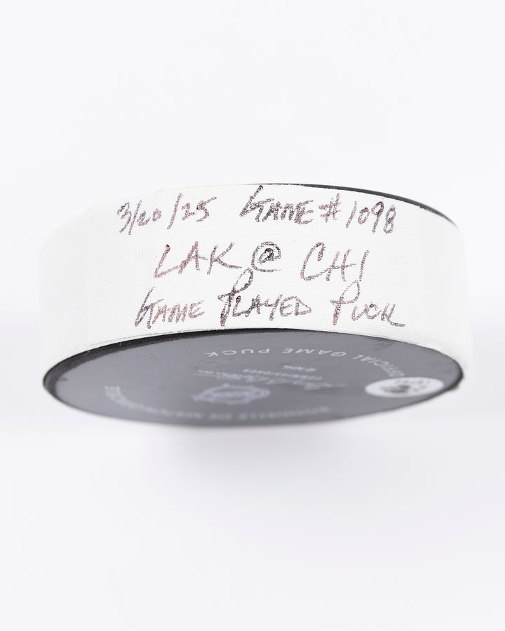 official Chicago Blackhawks hockey puck used in game against Los Angles Kings on 3/20/5 - tape detail lay flat