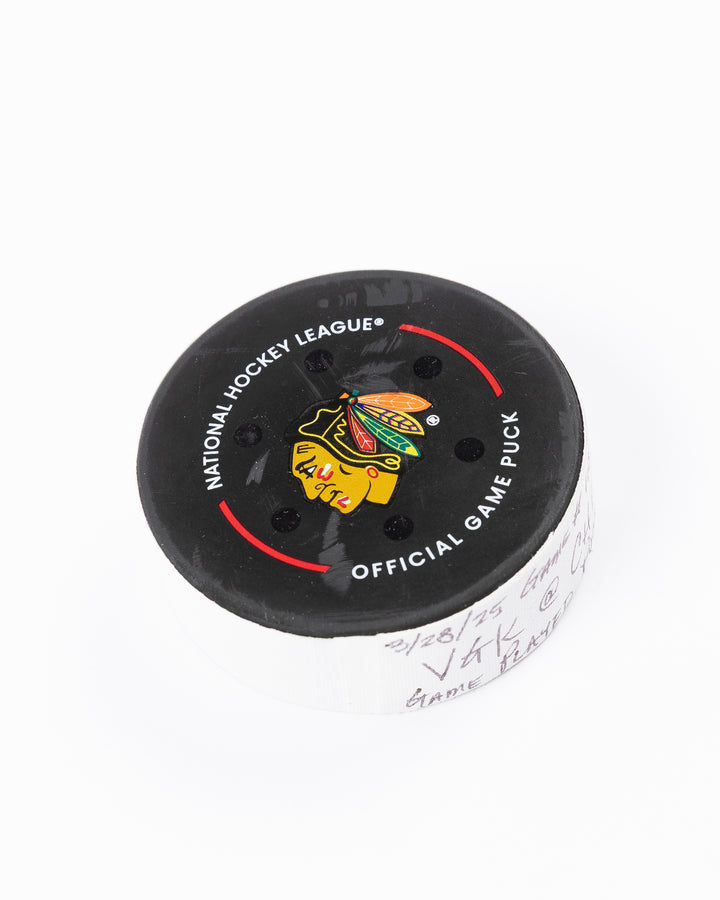 official Chicago Blackhawks hockey puck used in the game against the Vegas Golden Knights on 3/28/25 - front angle lay flat