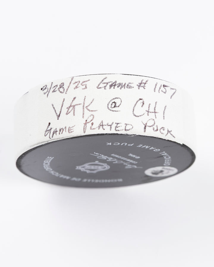 official Chicago Blackhawks hockey puck used in the game against the Vegas Golden Knights on 3/28/25 - tape detail lay flat