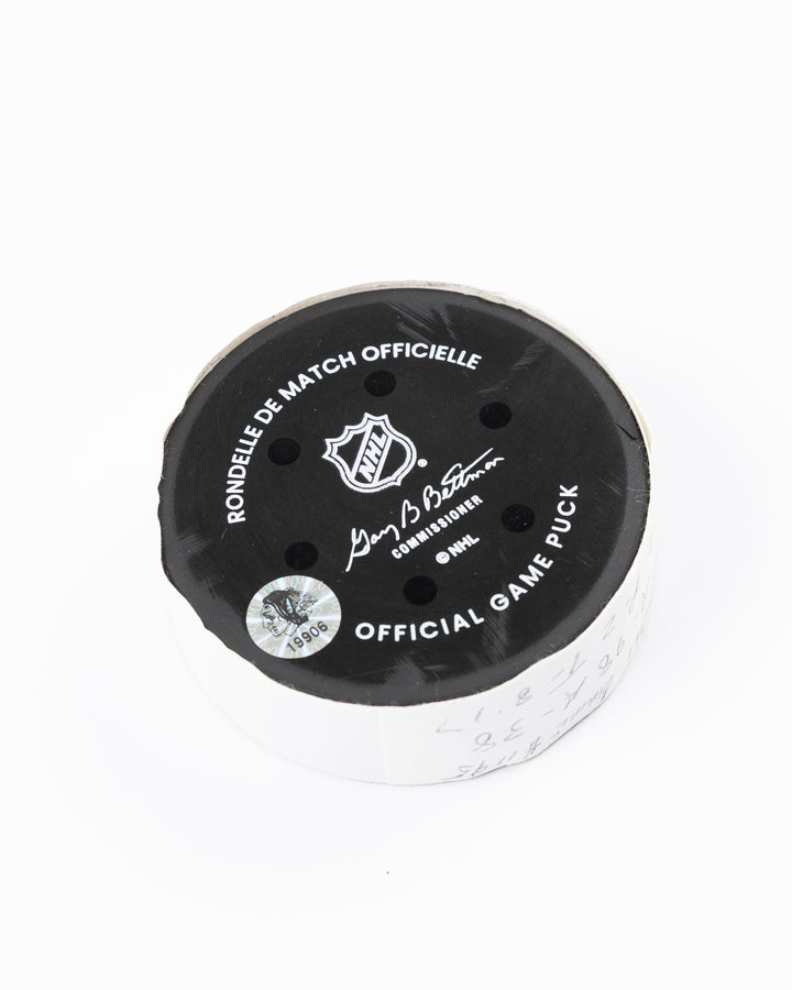 official hockey goal puck scored by Chicago Blackhawks player Connor Murphy  back angle lay flat