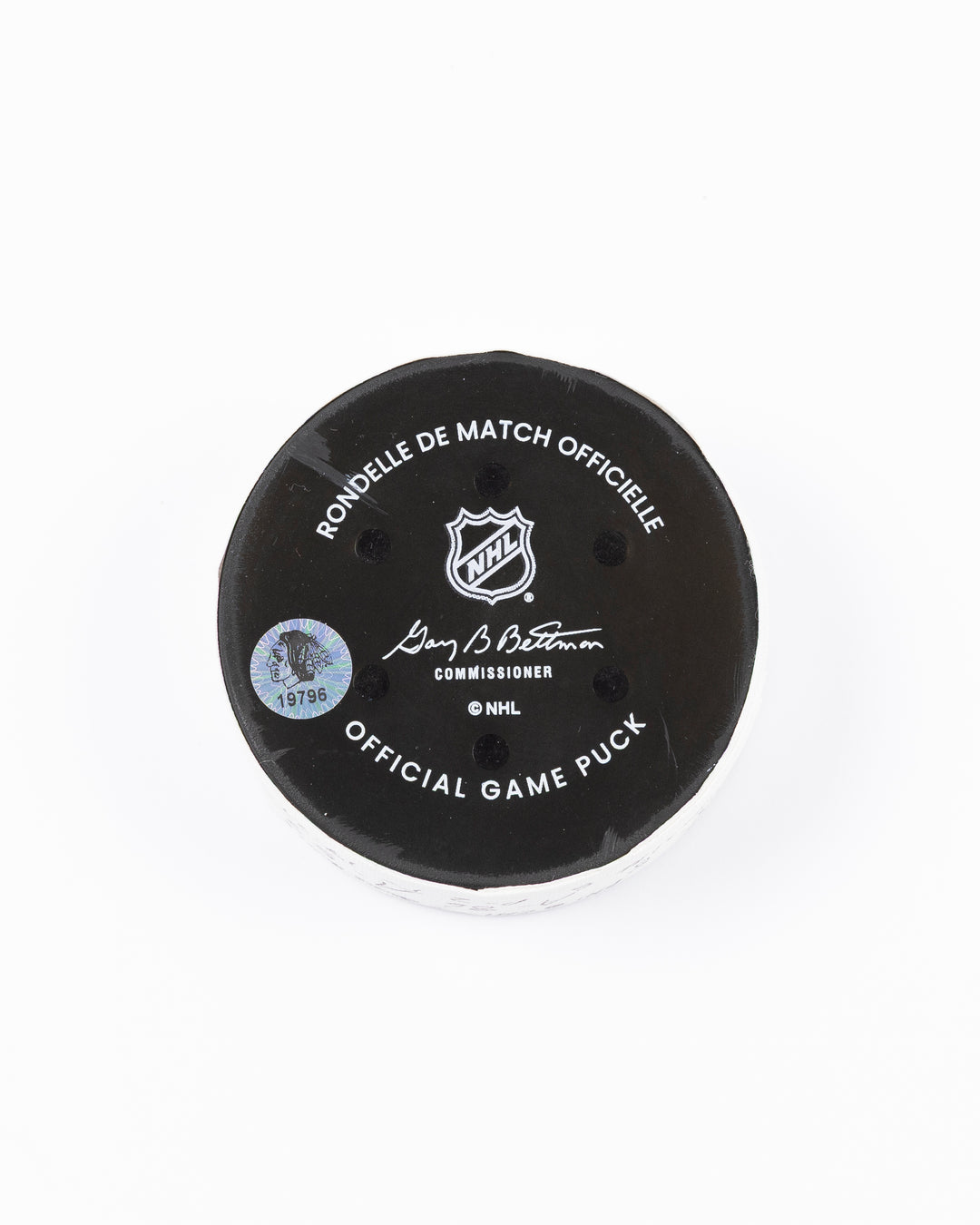 official hockey goal puck scored by Chicago Blackhawks player Ryan Donato on 3/23/25 - back lay flat
