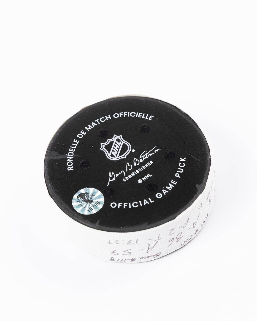 official hockey goal puck scored by Chicago Blackhawks player Ryan Donato on 3/23/25 - back angle lay flat