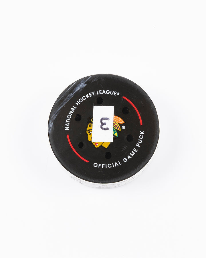 official hockey goal puck used by Chicago Blackhawks player Tyler Bertuzzi on 3/26/25 - front lay flat