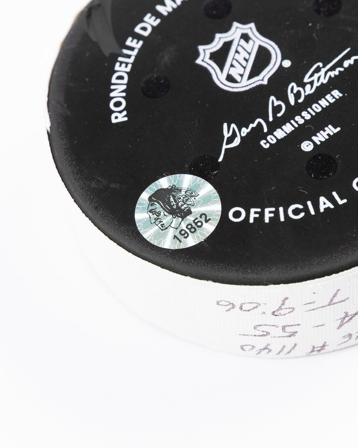 official hockey goal puck used by Chicago Blackhawks player Tyler Bertuzzi on 3/26/25 - hologram sticker detail lay flat