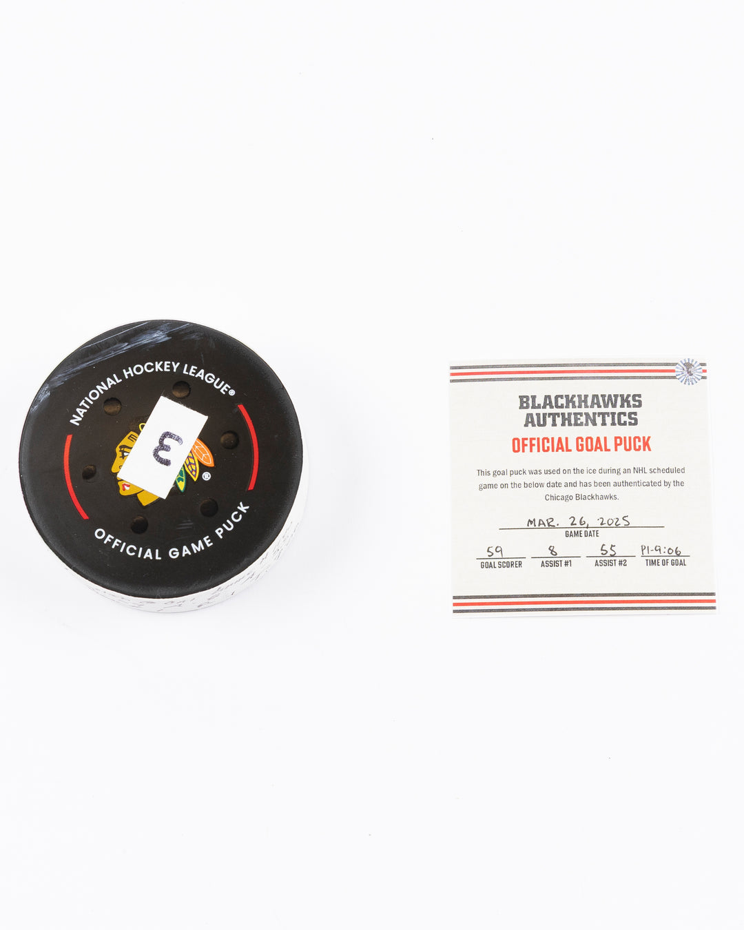 official hockey goal puck used by Chicago Blackhawks player Tyler Bertuzzi on 3/26/25 - front lay flat puck and certificate