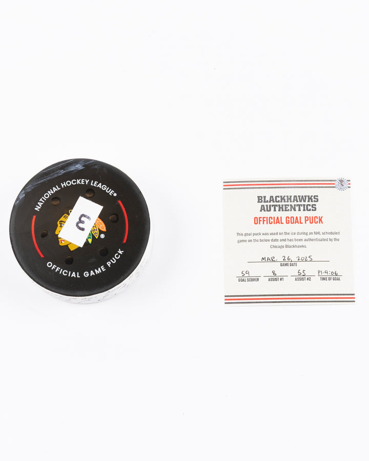 official hockey goal puck used by Chicago Blackhawks player Tyler Bertuzzi on 3/26/25 - front lay flat puck and certificate
