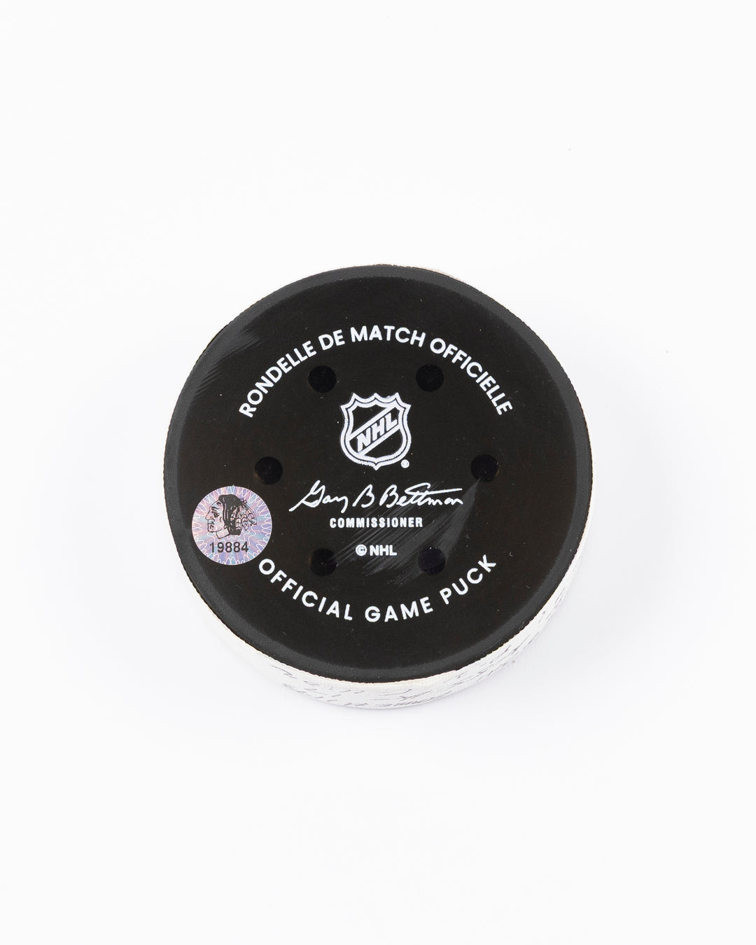 official hockey goal puck scored by Chicago Blackhawks player Joe Veleno on 3/28/25 - back lay flat