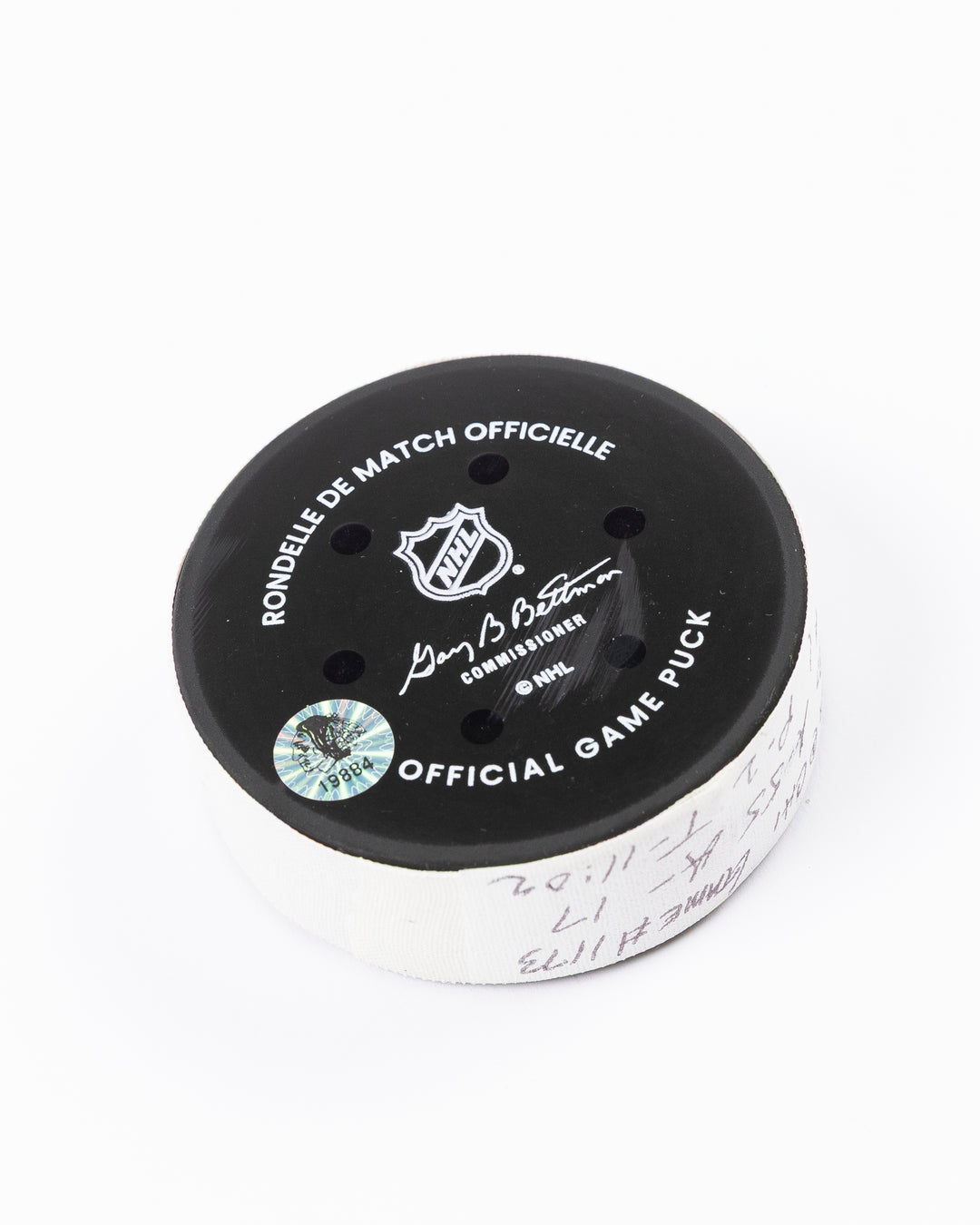 official hockey goal puck scored by Chicago Blackhawks player Joe Veleno on 3/28/25 - back angle lay flat