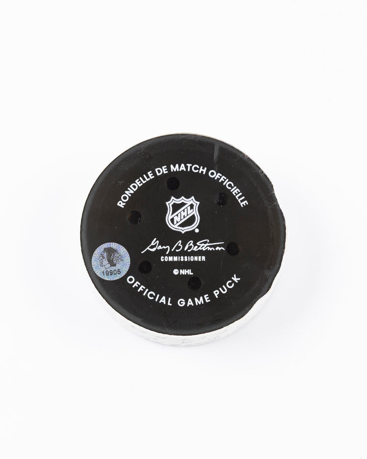 official hockey goal puck scored by Chicago Blackhawks player Ilya Mikheyev on 4/2/25 - back lay flat
