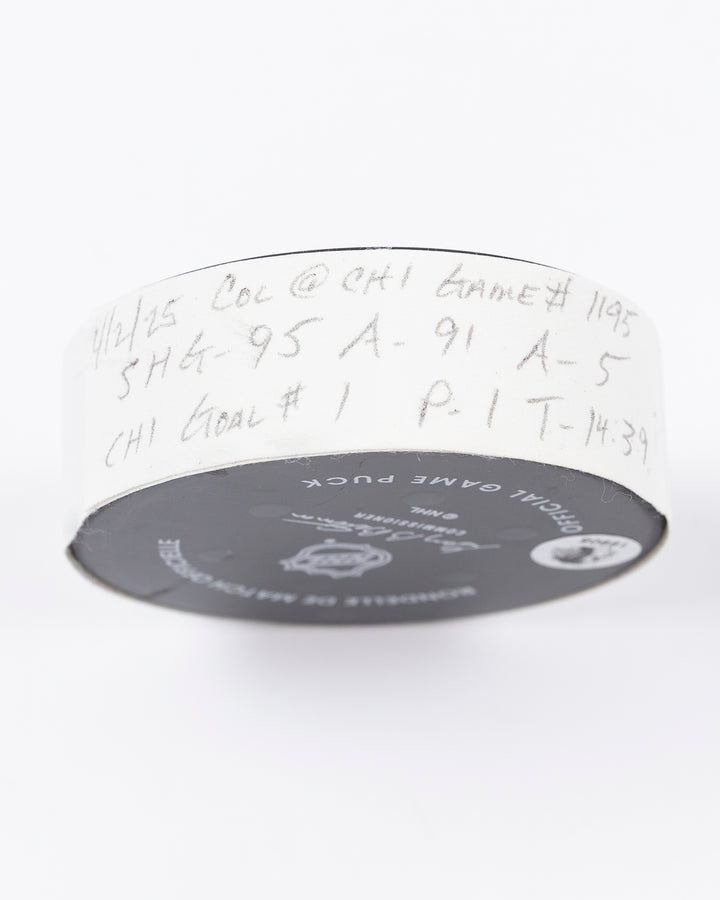 official hockey goal puck scored by Chicago Blackhawks player Ilya Mikheyev on 4/2/25 - tape detail lay flat