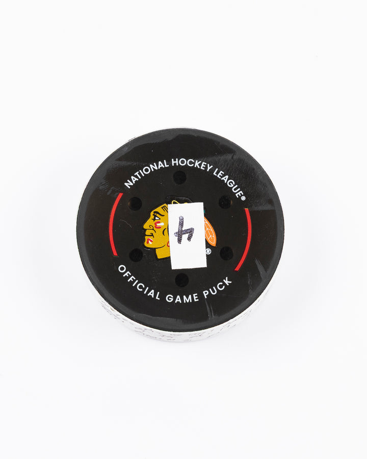 official hockey goal puck scored by Chicago Blackhawks player Ilya Mikheyev - front lay flat