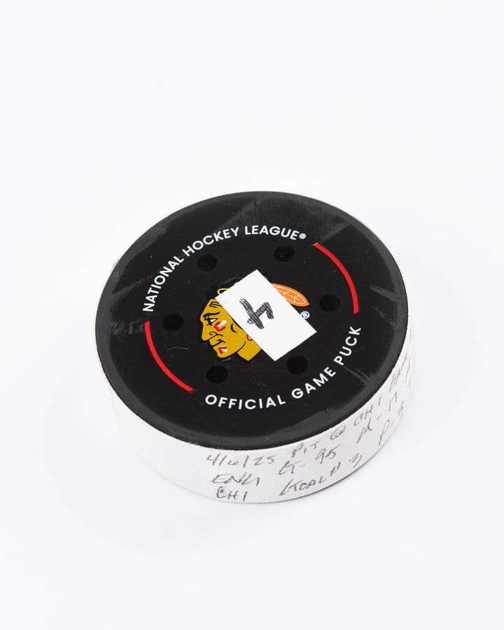 official hockey goal puck scored by Chicago Blackhawks player Ilya Mikheyev - front angle lay flat