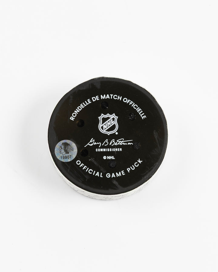 official hockey goal puck scored by Chicago Blackhawks player Ilya Mikheyev - back lay flat