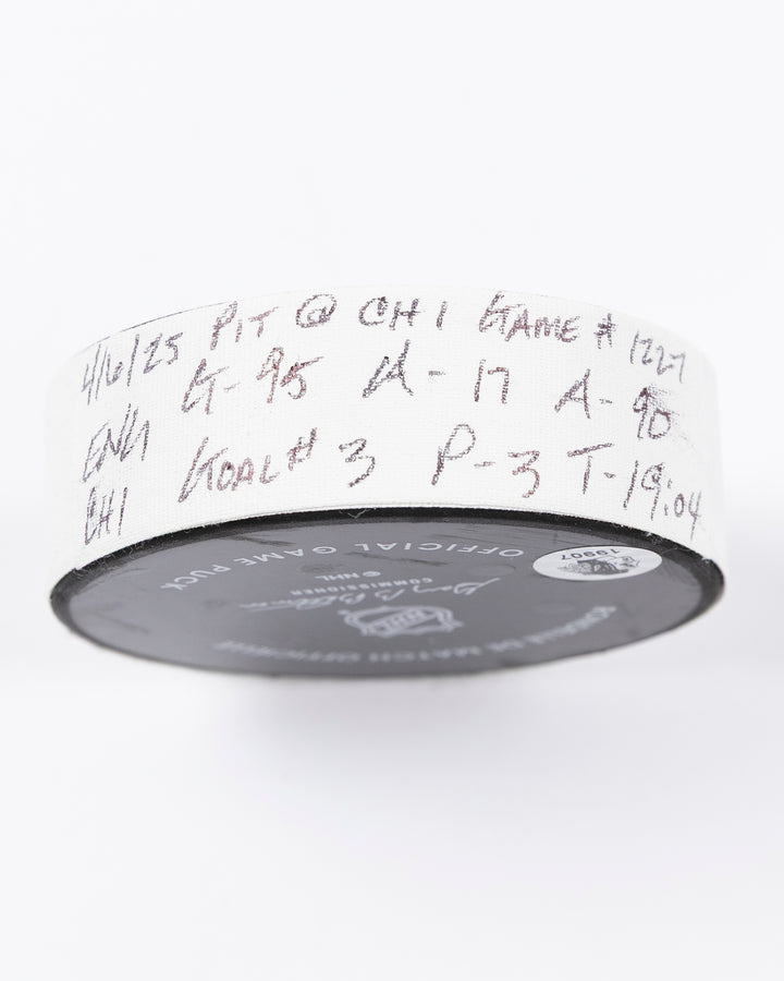 official hockey goal puck scored by Chicago Blackhawks player Ilya Mikheyev - tape detail lay flat