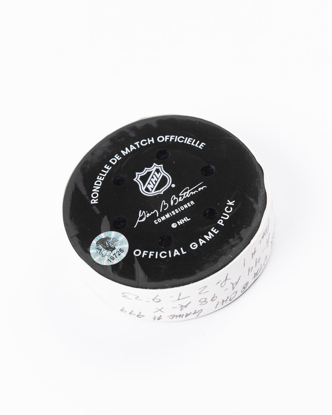 official game used hockey goal puck scored by Chicago Blackhawks player Wyatt Kaiser - back angle lay flat