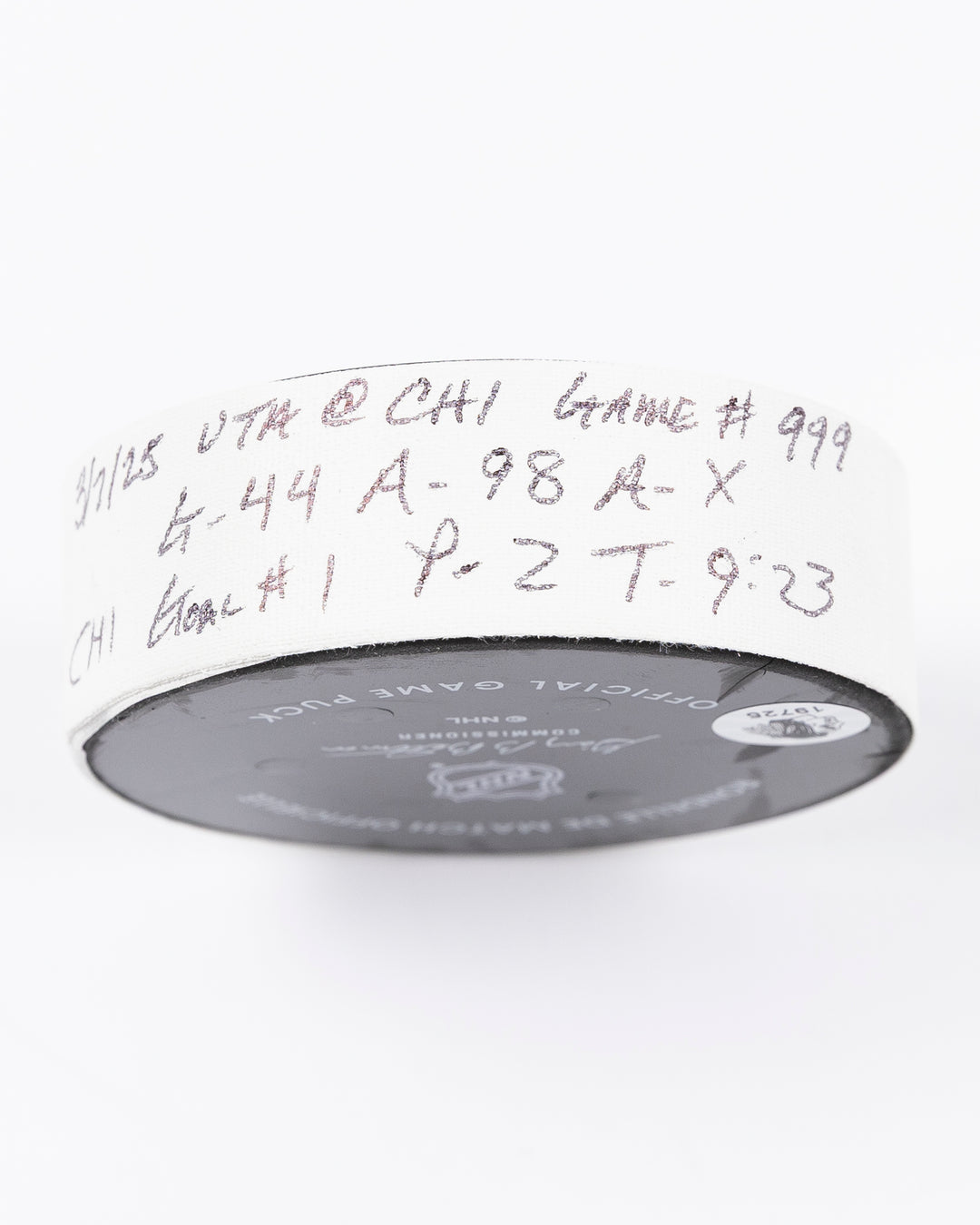 official game used hockey goal puck scored by Chicago Blackhawks player Wyatt Kaiser - tape detail lay flat