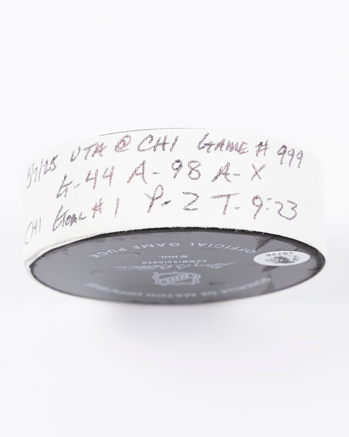 official game used hockey goal puck scored by Chicago Blackhawks player Wyatt Kaiser - tape detail lay flat