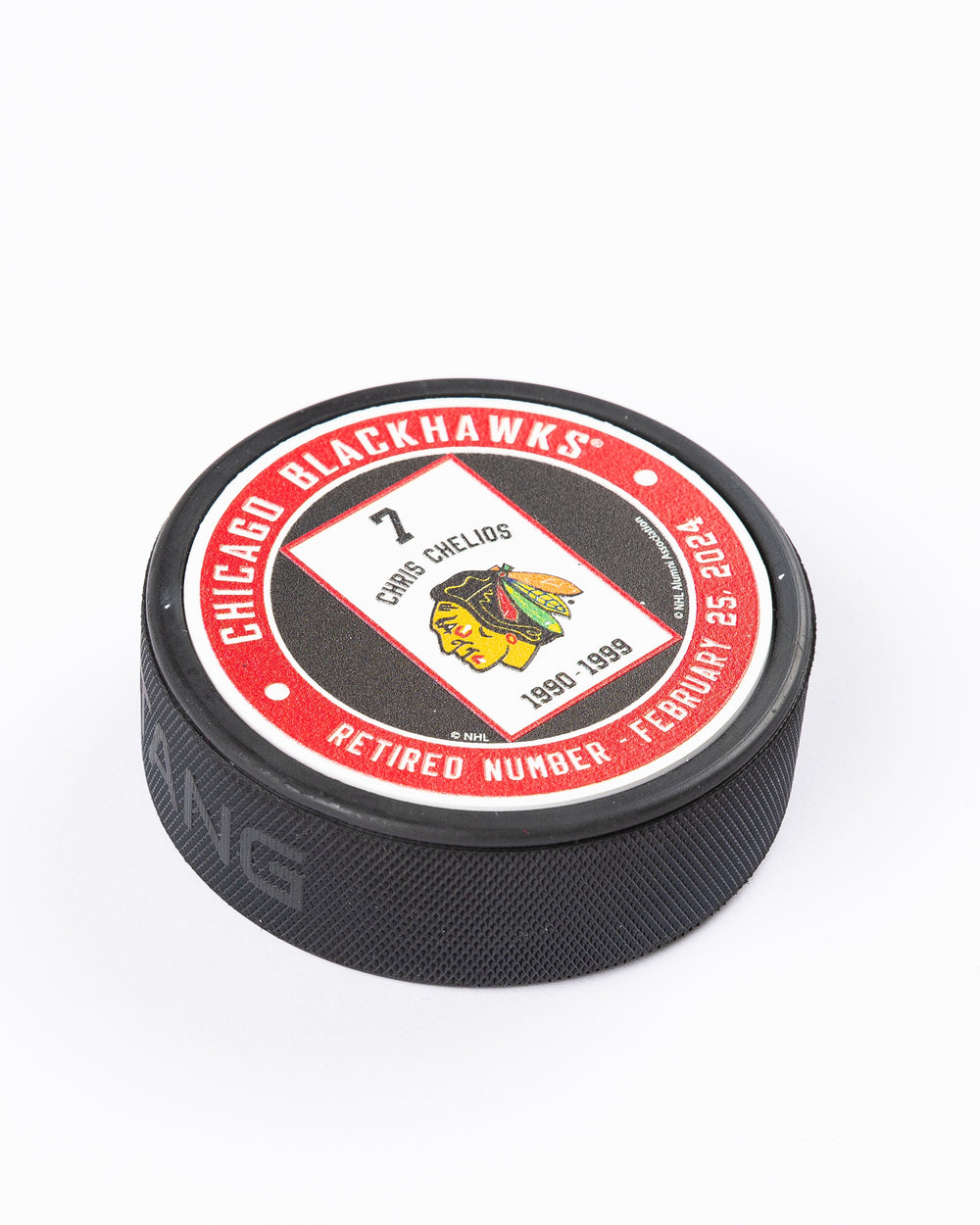 Mustang hockey puck with Chris Chelios retirement banner graphic - detail lay flat