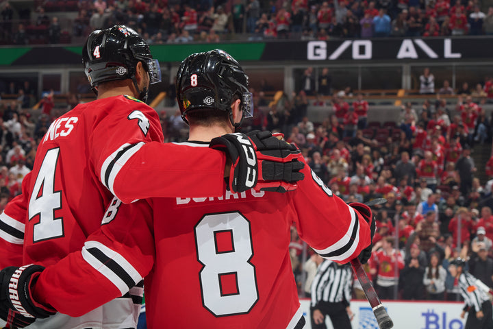 Ryan Donato celebrating with Jones after scoring during Chicago Blackhawks game on October 22, 2024