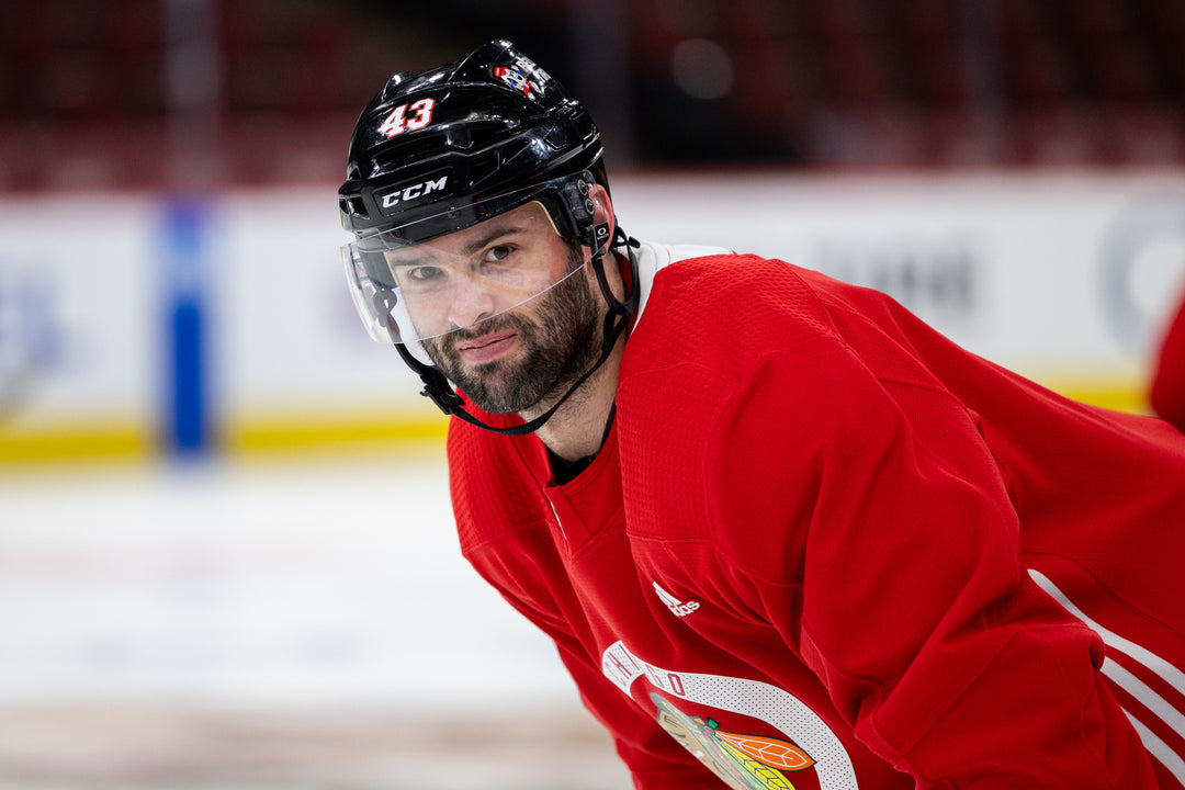 Chicago Blackhawks player Colin Blackwell wearing black CCM hockey helmet and red practice jersey