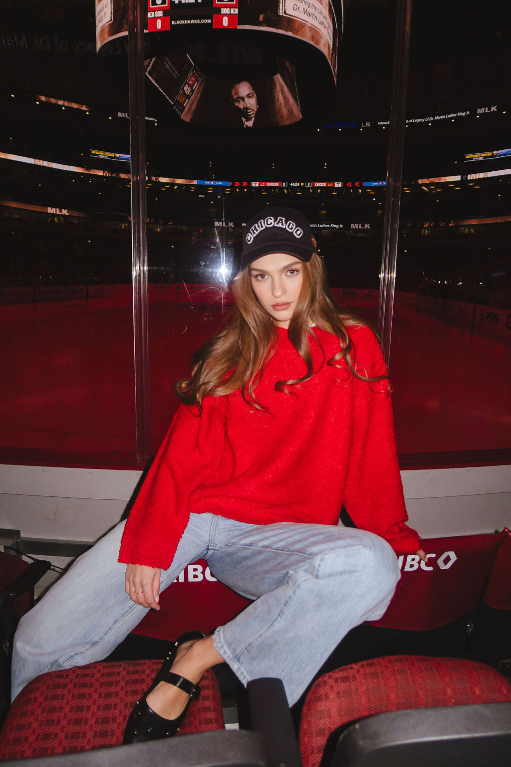 woman wearing black Alice & Wonder adjustable hat with chainstiched Chicago graphic on front and Chicago Blackhawks primary logo on left side