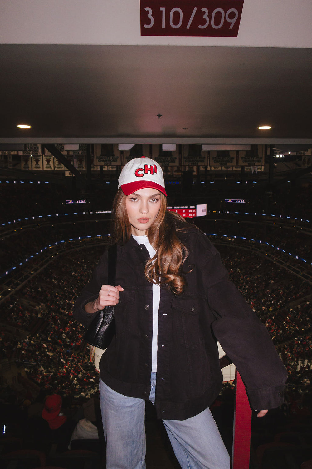 woman wearing two tone red and white Alice & Wonder baseball hat with embroidered CHI detailing on front and Blackhawks wordmark on back