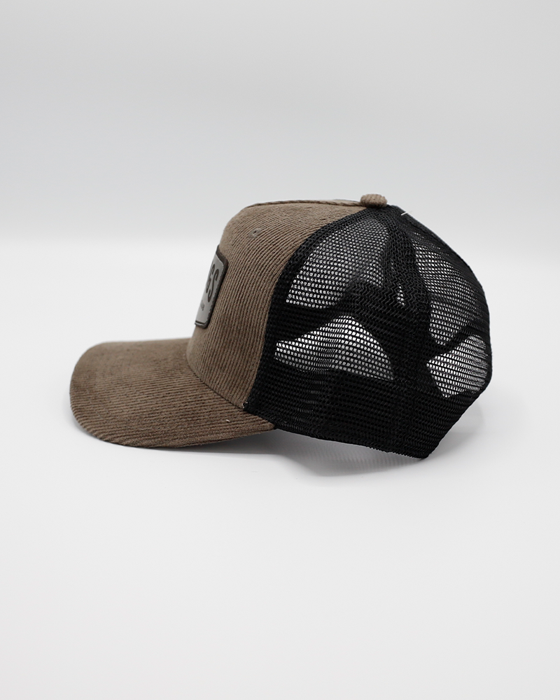 Legacy brown corduroy trucker with black mesh and Rockford IceHogs Hockey Club patch on front - left side lay flat