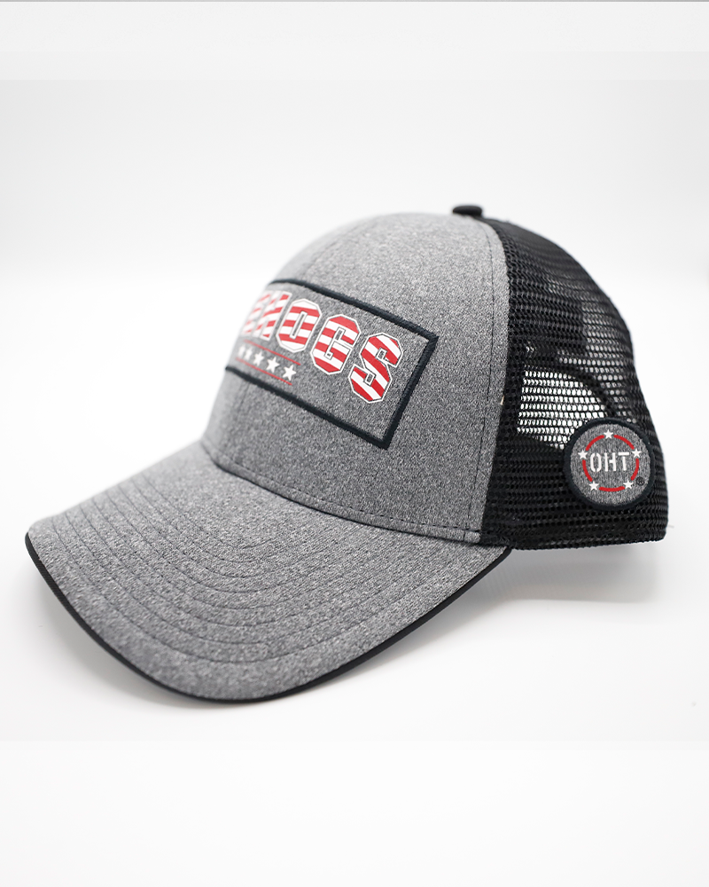 grey Colosseum trucker with Rockford IceHogs wordmark in American flag colorway and American flag patch embroidered on back - left angle lay flat