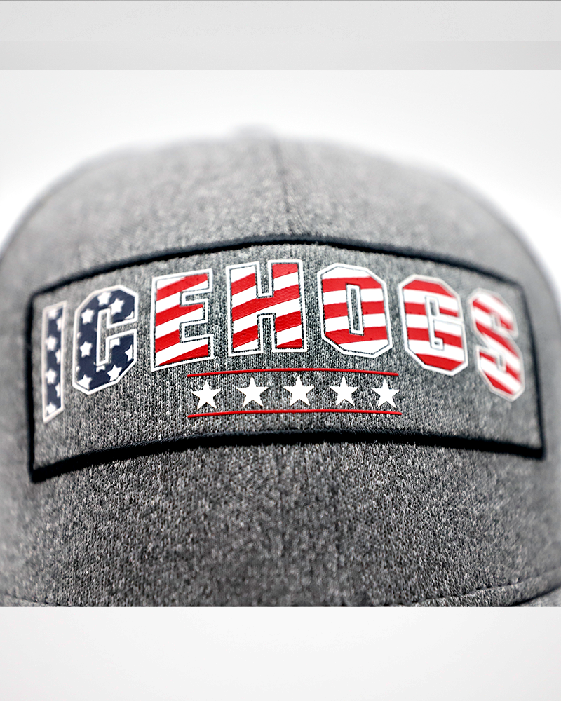 grey Colosseum trucker with Rockford IceHogs wordmark in American flag colorway and American flag patch embroidered on back - front detail lay flat