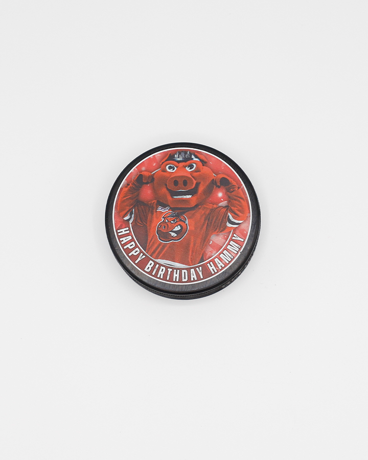 black hockey puck with Happy Birthday Hammy wordmark and photo of Rockford IceHogs mascot Hammy on front - front lay flat