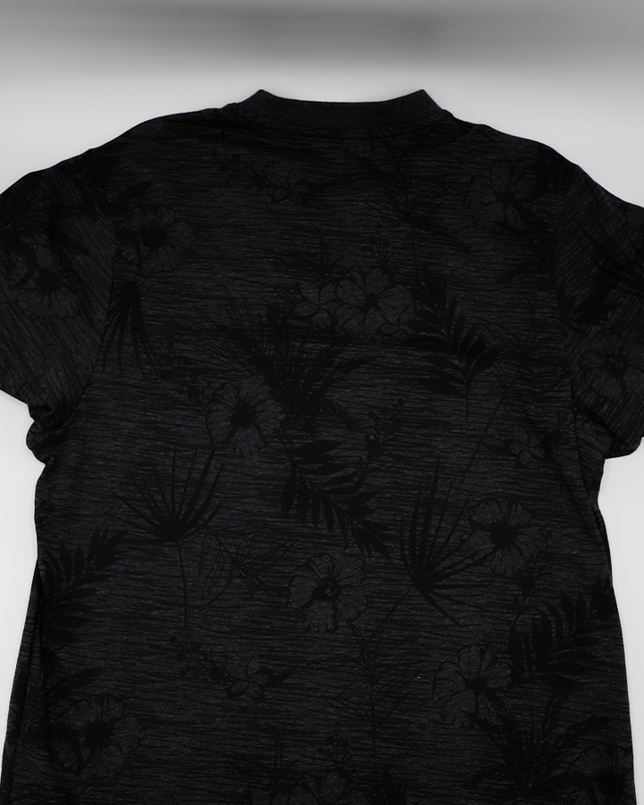 Colosseum collard short sleeve tee with black floral all over pattern with Rockford IceHogs primary logo on left chest - back lay flat