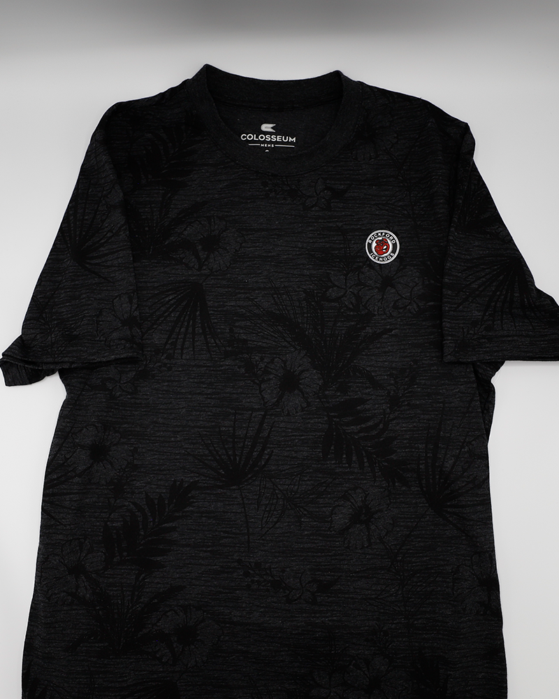 Colosseum collard short sleeve tee with black floral all over pattern with Rockford IceHogs primary logo on left chest - front lay flat