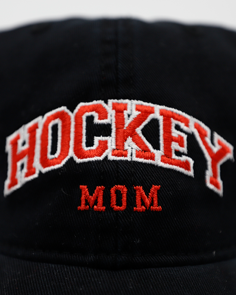 black Legacy adjustable hat with embroidered red Hockey Mom wordmark on front and Rockford IceHogs Hammy logo on left side - front detail lay flat