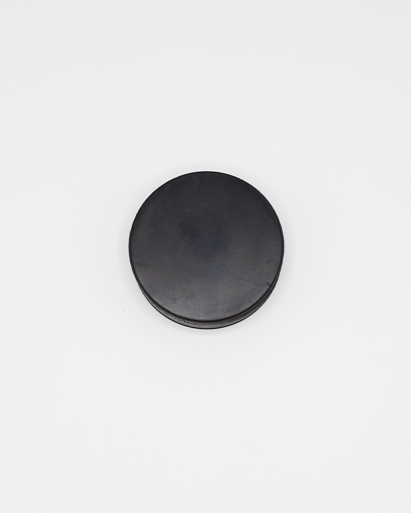 black hockey puck with Screw City Hockey wordmark and R graphic on the front - back lay flat